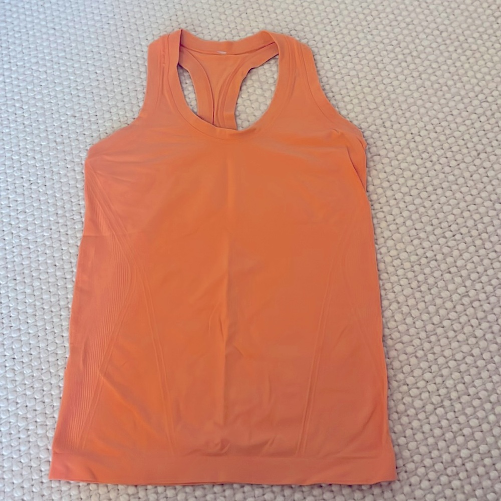 Coral orange Athleta tank top.